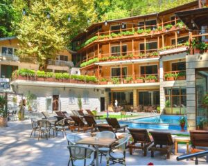 Почивка край Петрич! Нощувка на човек със закуска и възможност за вечеря + външен басейн, сауна и топло джакузи на покрива от хотел Света Неделя, с. Коларово